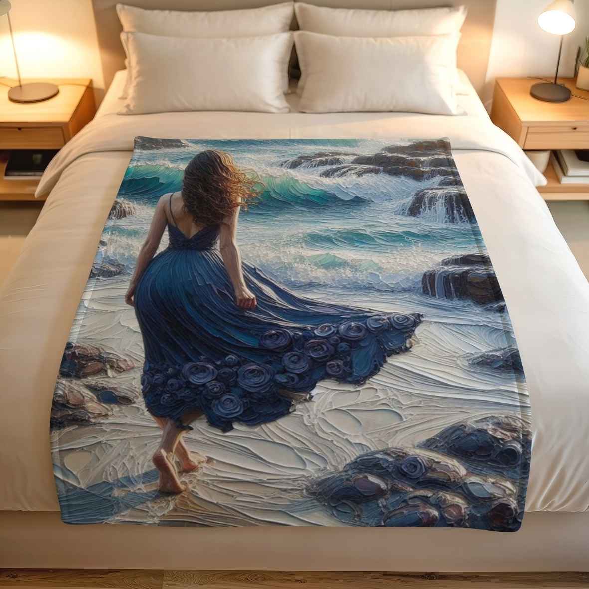 Custom printed coastal fleece blanket with exclusive Lily Grace Design artwork featuring ocean waves, dark rocks and a woman in a blue dress.