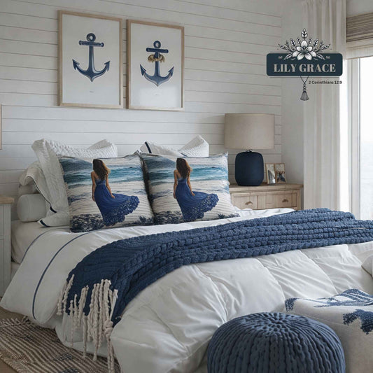 Blue cushion covers styled on a white bed with navy throw in a coastal bedroom setting