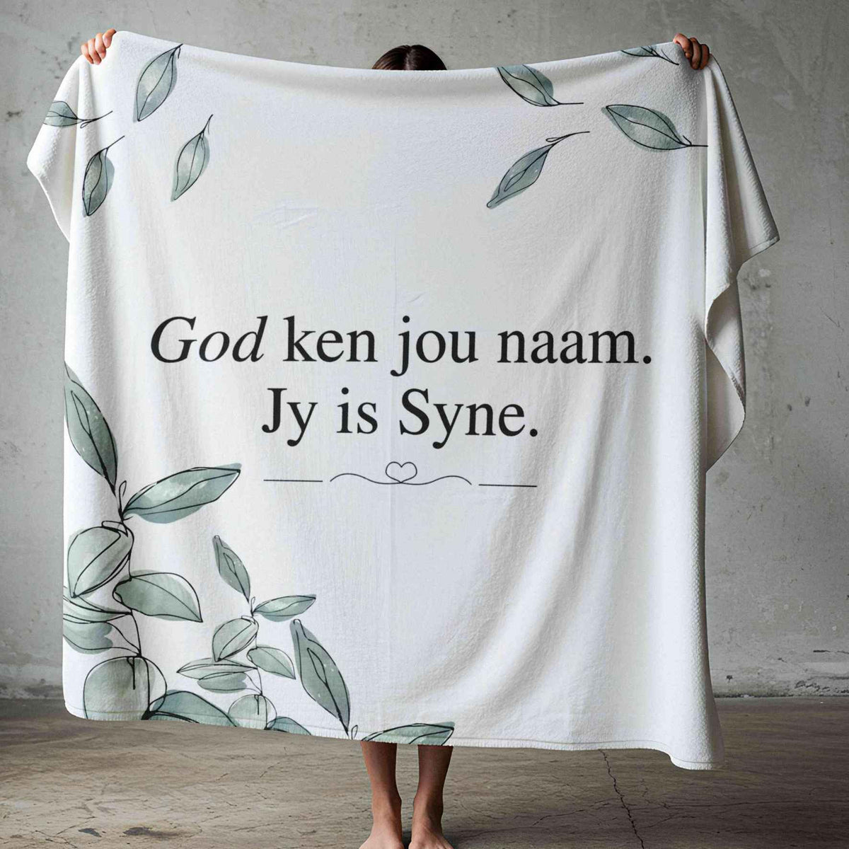 God Ken Jou Naam lightweight Afrikaans fleece blanket with sage-green watercolour leaves on a white background