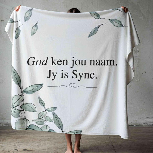 God Ken Jou Naam lightweight Afrikaans fleece blanket with sage-green watercolour leaves on a white background