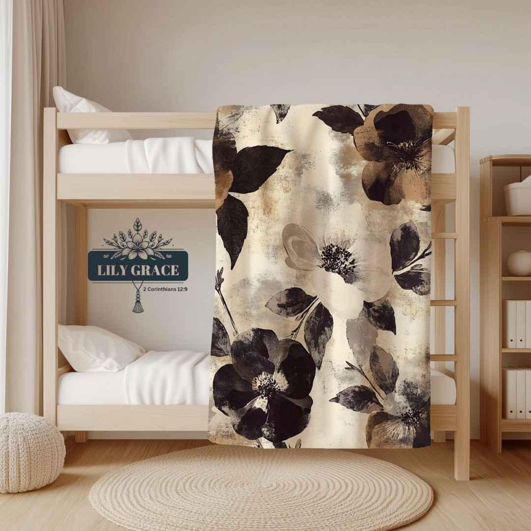 Neutral floral fleece blanket draped over a bunk bed in beige and brown tones
