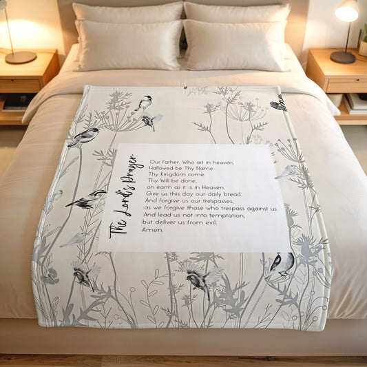 Blanket with bird and plant pattern on a bed in a bedroom setting