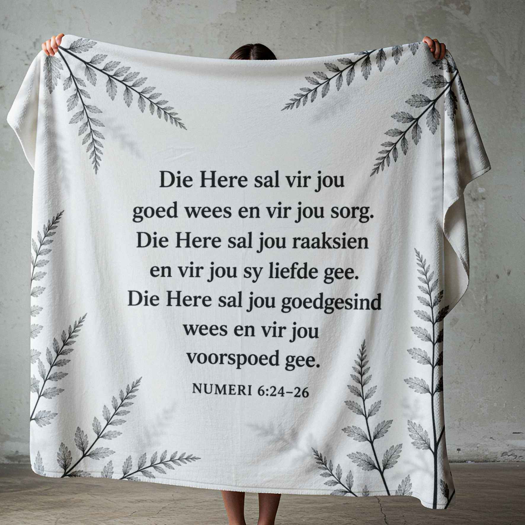 Square black-and-white botanical fleece blanket design featuring the Afrikaans Numeri 6:24–26 blessing in clear black text.
