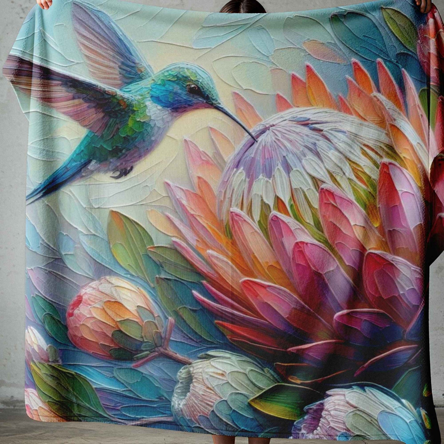 Lightweight fleece blanket with colourful hummingbird and protea floral design, printed in South Africa.