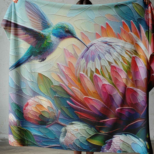 Lightweight fleece blanket with colourful hummingbird and protea floral design, printed in South Africa.