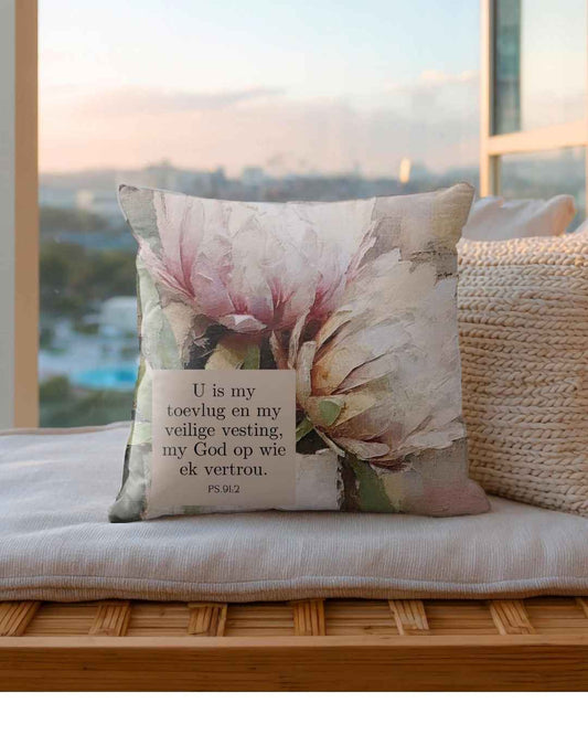 Matching scatter cushion cover featuring soft watercolor pink protea artwork with the Afrikaans Bible verse "U is my toevlug en my veilige vesting, my God op wie ek vertrou" (Psalm 91:2), available as a Christian decorative cushion cover in South Africa.
