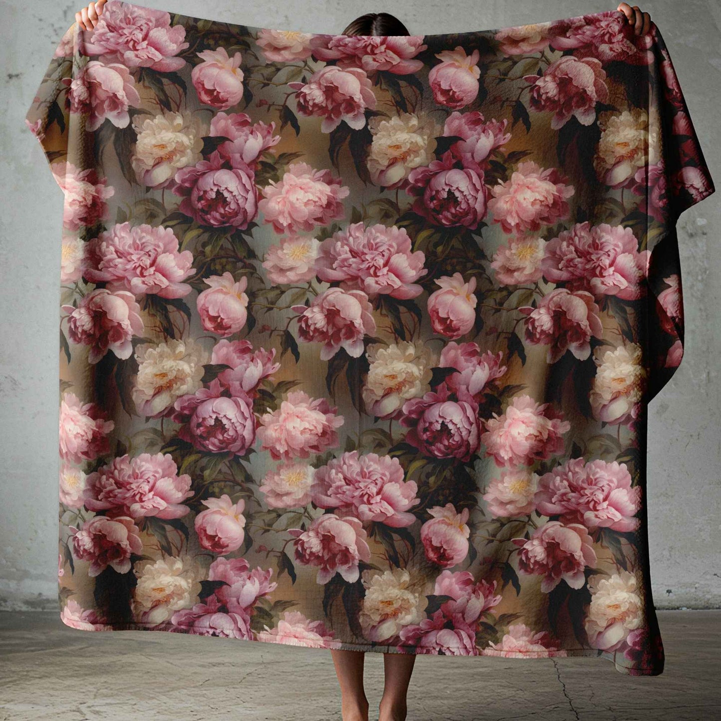 Lightweight fleece blanket with soft pink floral design on a moody dark background for South African homes.