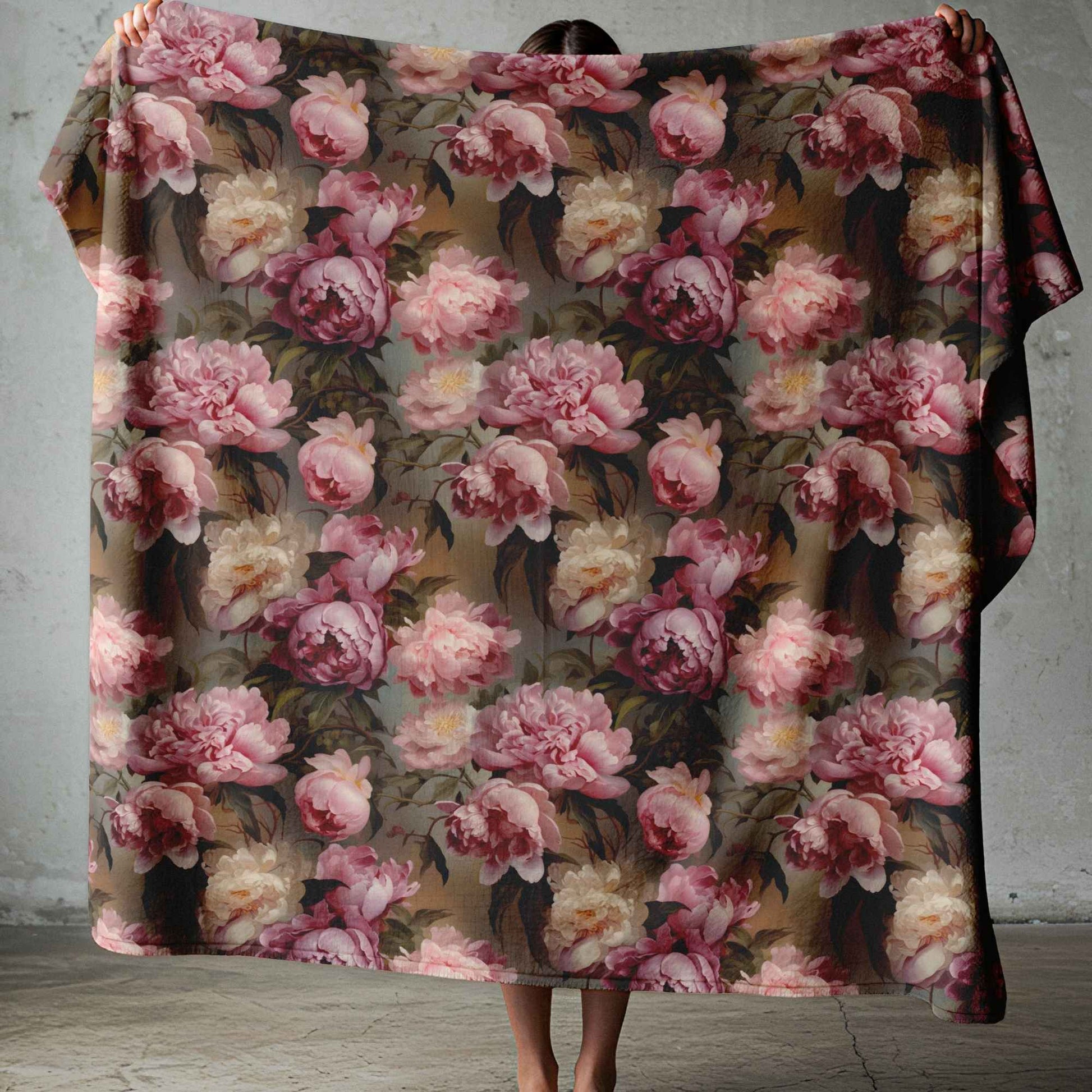 Lightweight fleece blanket with soft pink floral design on a moody dark background for South African homes.