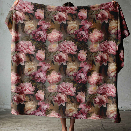 Lightweight fleece blanket with soft pink floral design on a moody dark background for South African homes.