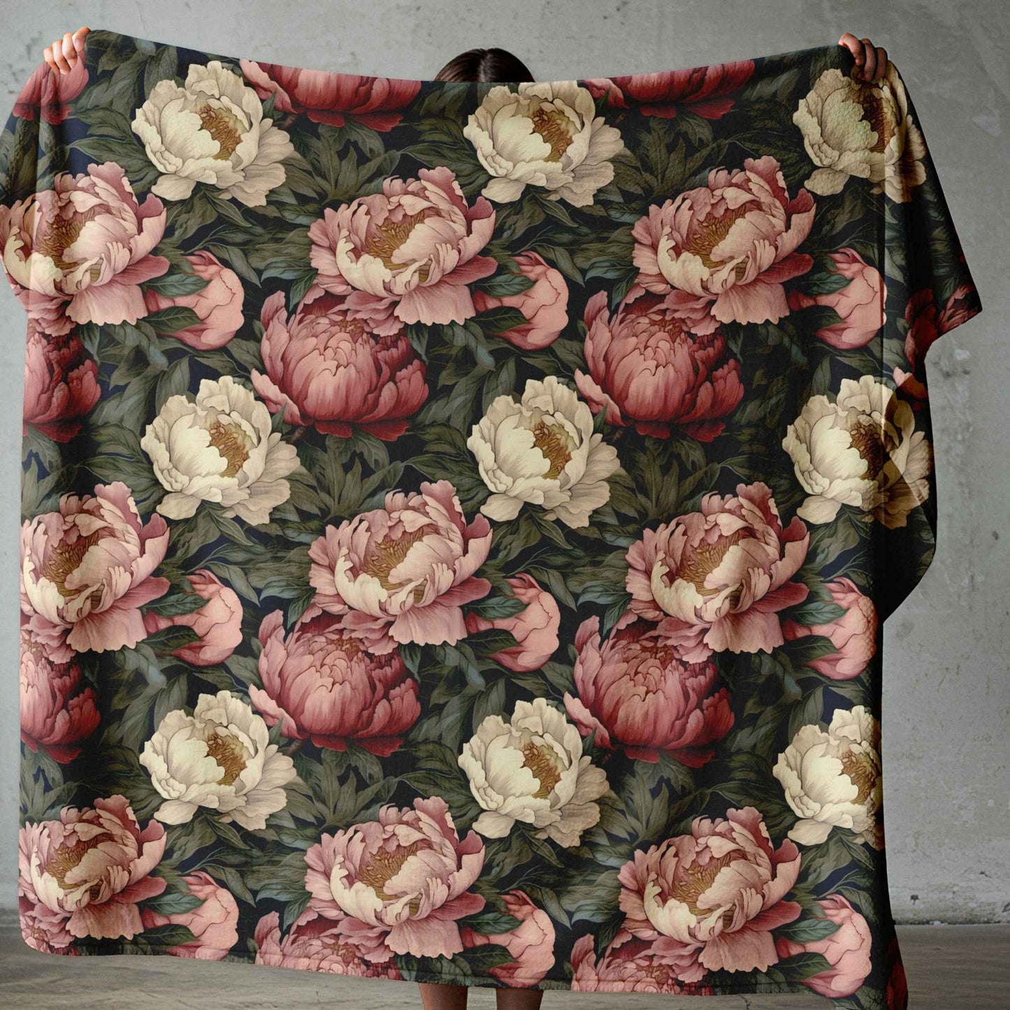 Lightweight fleece blanket with pink and cream floral design on a dark botanical background, printed in South Africa.