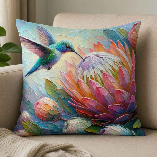 Hummingbird and protea cotton scatter cushion cover styled on a neutral sofa in a South African home