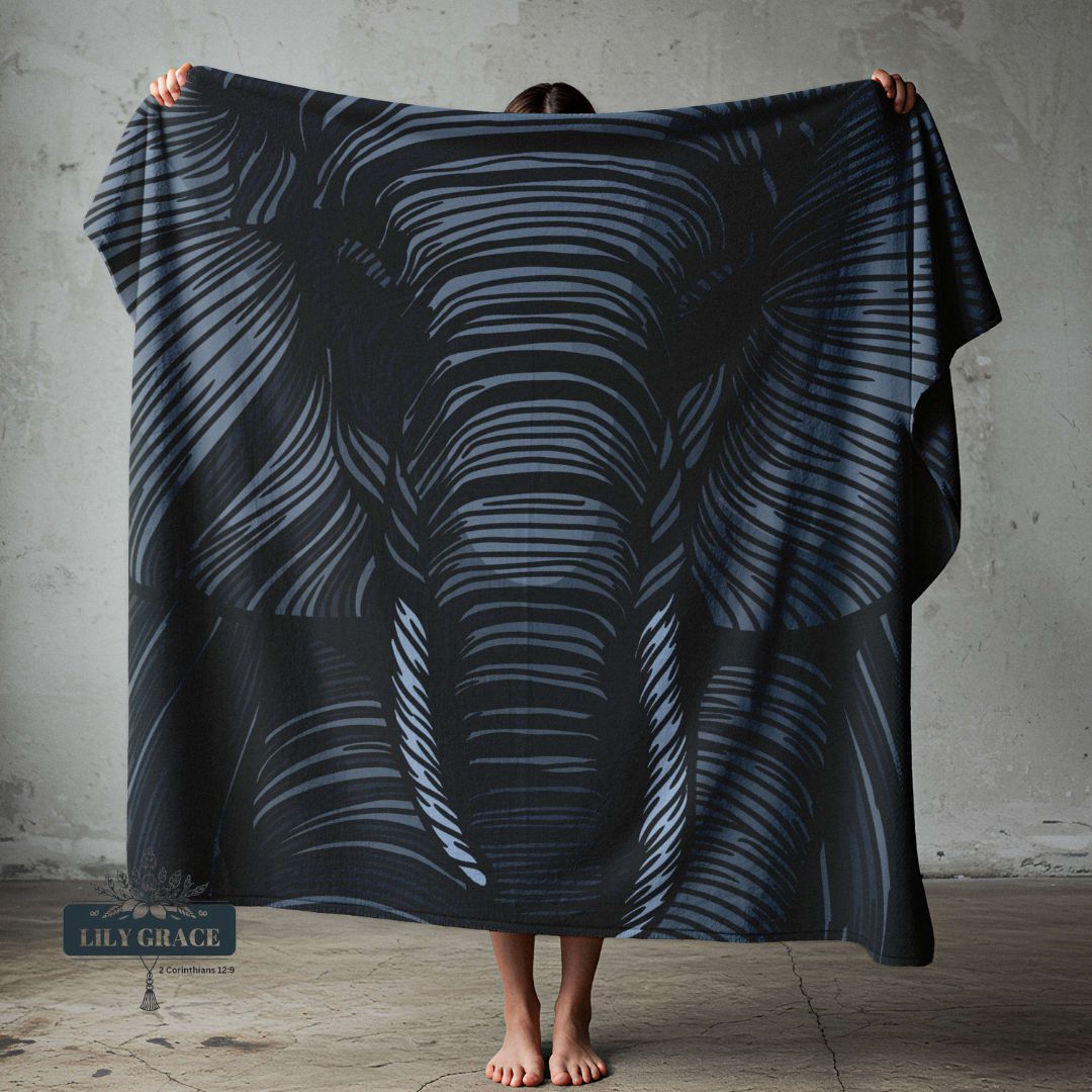 Person holding a large fleece blanket featuring elephant animal print