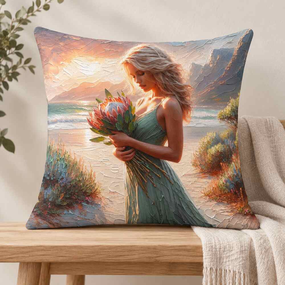 Coastal protea woman scatter cushion on a light wooden bench with soft neutral styling in South Africa.