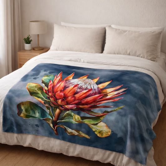 Protea fleece blanket South Africa, soft lightweight fleece throw on bed with bold red protea design