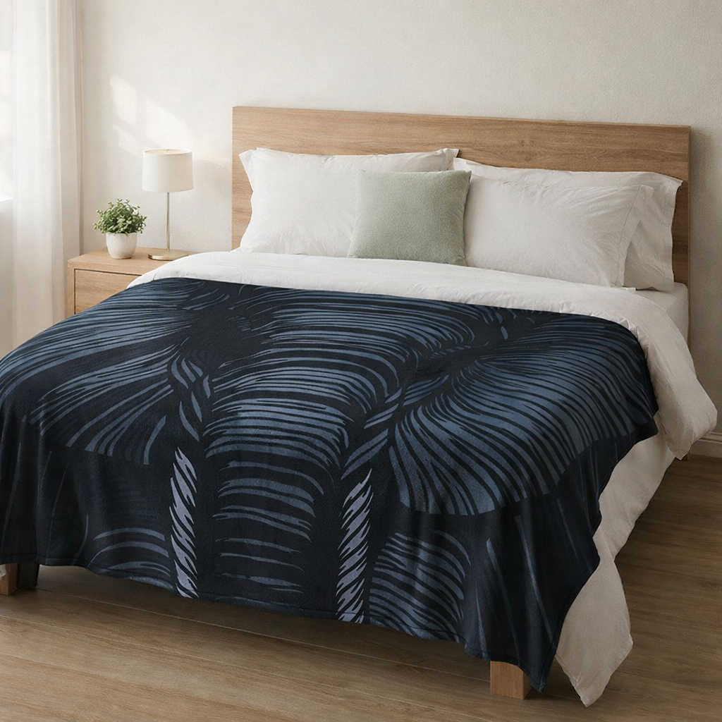 Bed with animal print thow blanket and white pillows in a bedroom setting.