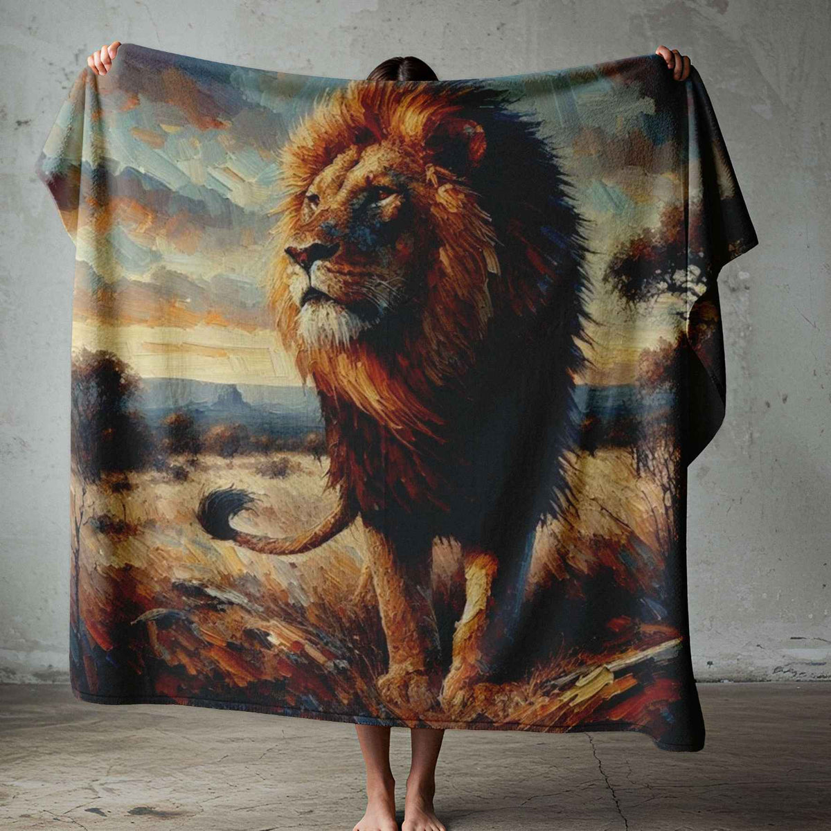 Lion print blanket held open, featuring a golden-maned lion against an African savanna landscape in earthy tones.